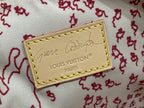 Louis Vuitton leather logo patch with gold stitching on light fabric background