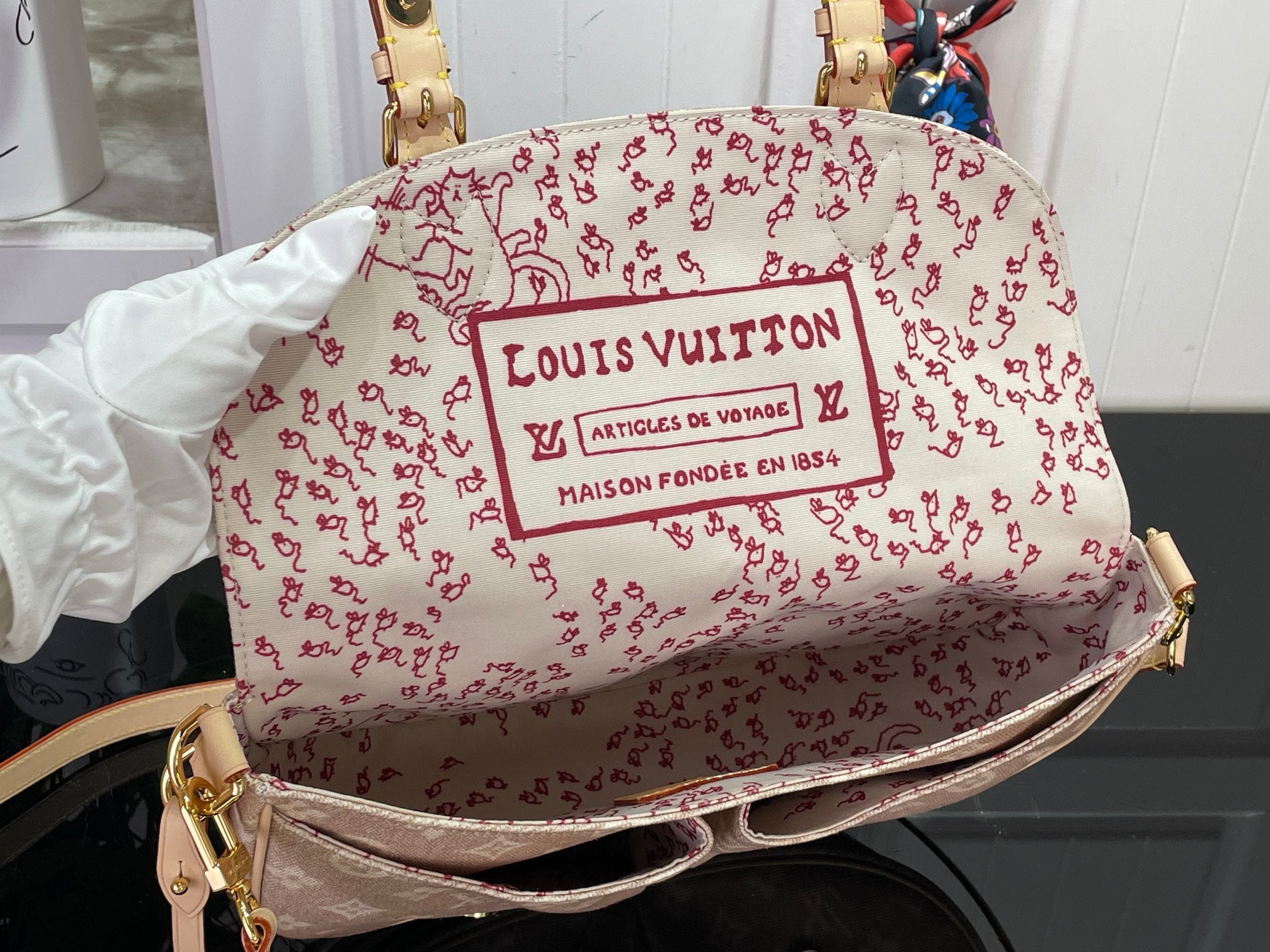 Louis Vuitton patterned shoulder bag in white with red logo print and top handle