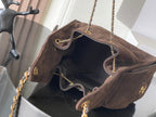 Chanel bag open top with interior lining, gold chain straps, and front logo detail