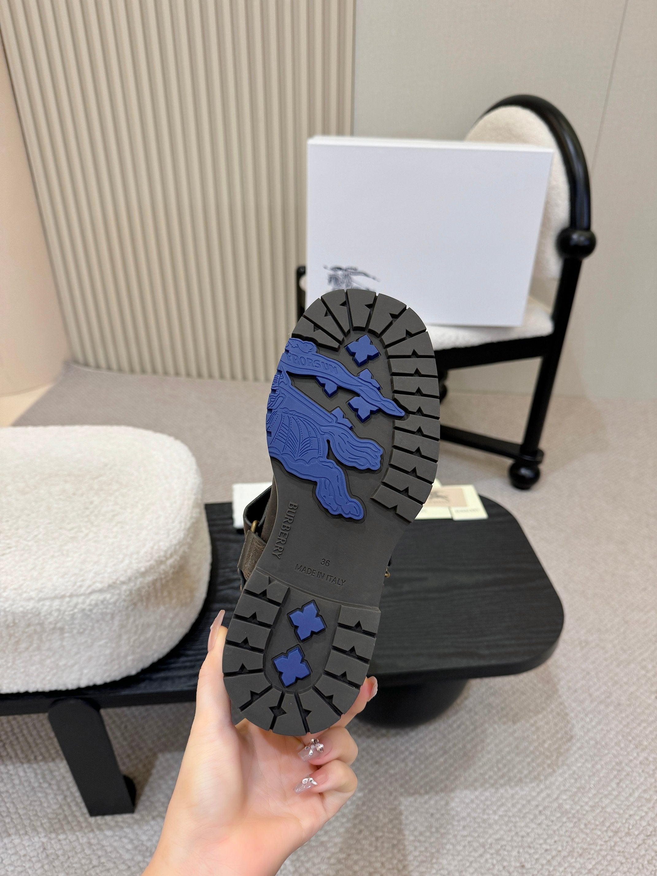Black boot outsole with blue lion graphic and grippy tread pattern