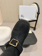 Black mid-calf boot with gold buckle strap, toe and vamp close-up