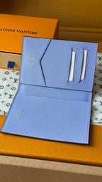 Light blue small pouch with stitched texture and two metal snap handles