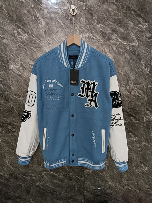 Blue and white varsity jacket with snap buttons and embroidered front patches