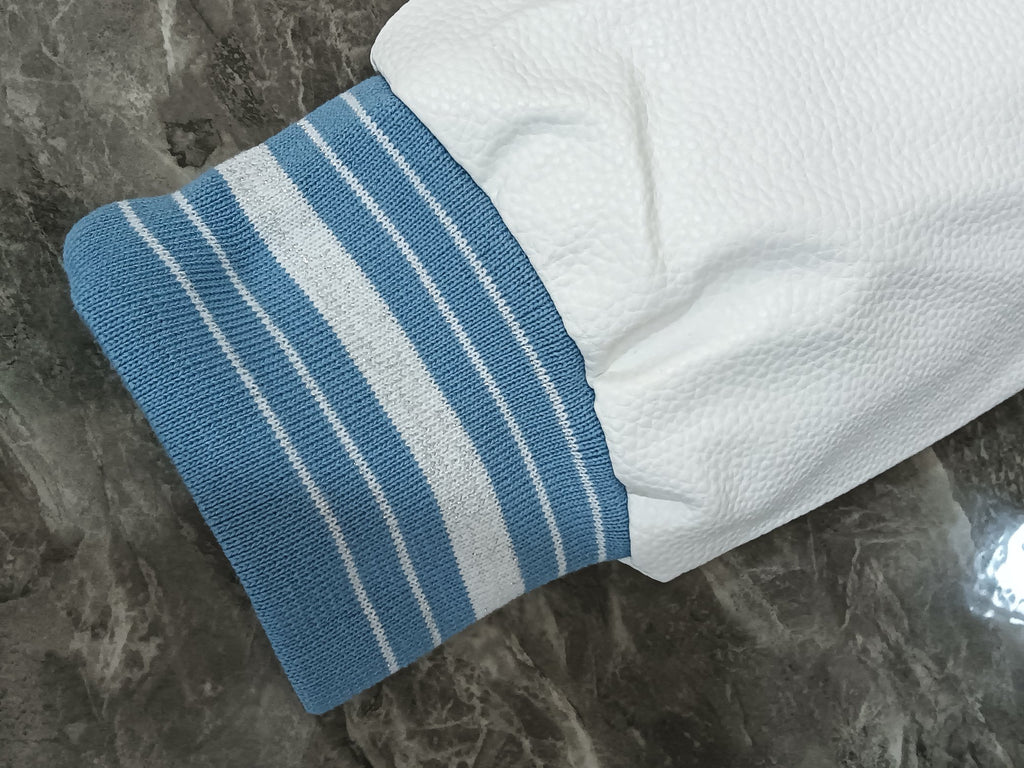 White and light blue striped ribbed cuff on the varsity jacket sleeve