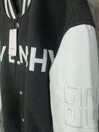Givenchy varsity jacket close-up: black body with white textured sleeves and logo