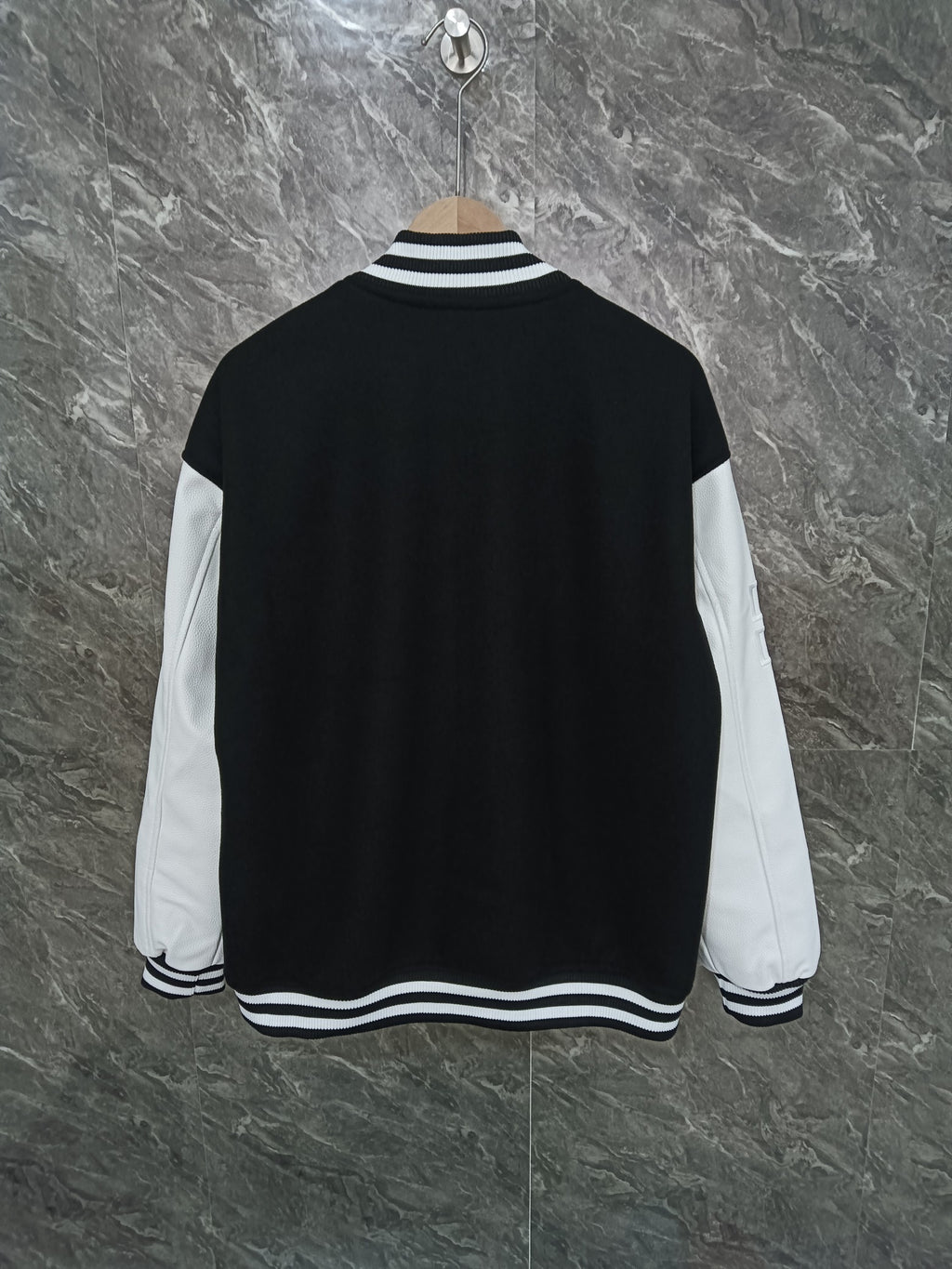 Givenchy black varsity jacket back view with white sleeves and striped collar hem