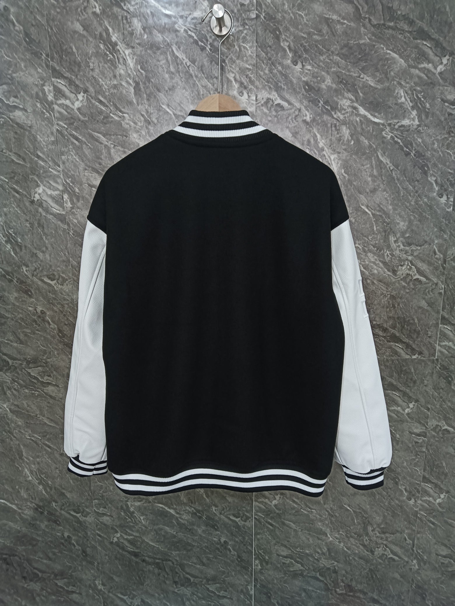 Givenchy black varsity jacket back view with white sleeves and striped collar hem