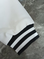 Givenchy varsity jacket sleeve: white textured finish with ribbed black-and-white cuff