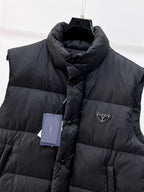 Close-up of dark hooded puffer vest with front button placket and logo triangle