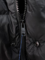 Close-up of dark zipper and snap buttons on hooded puffer vest