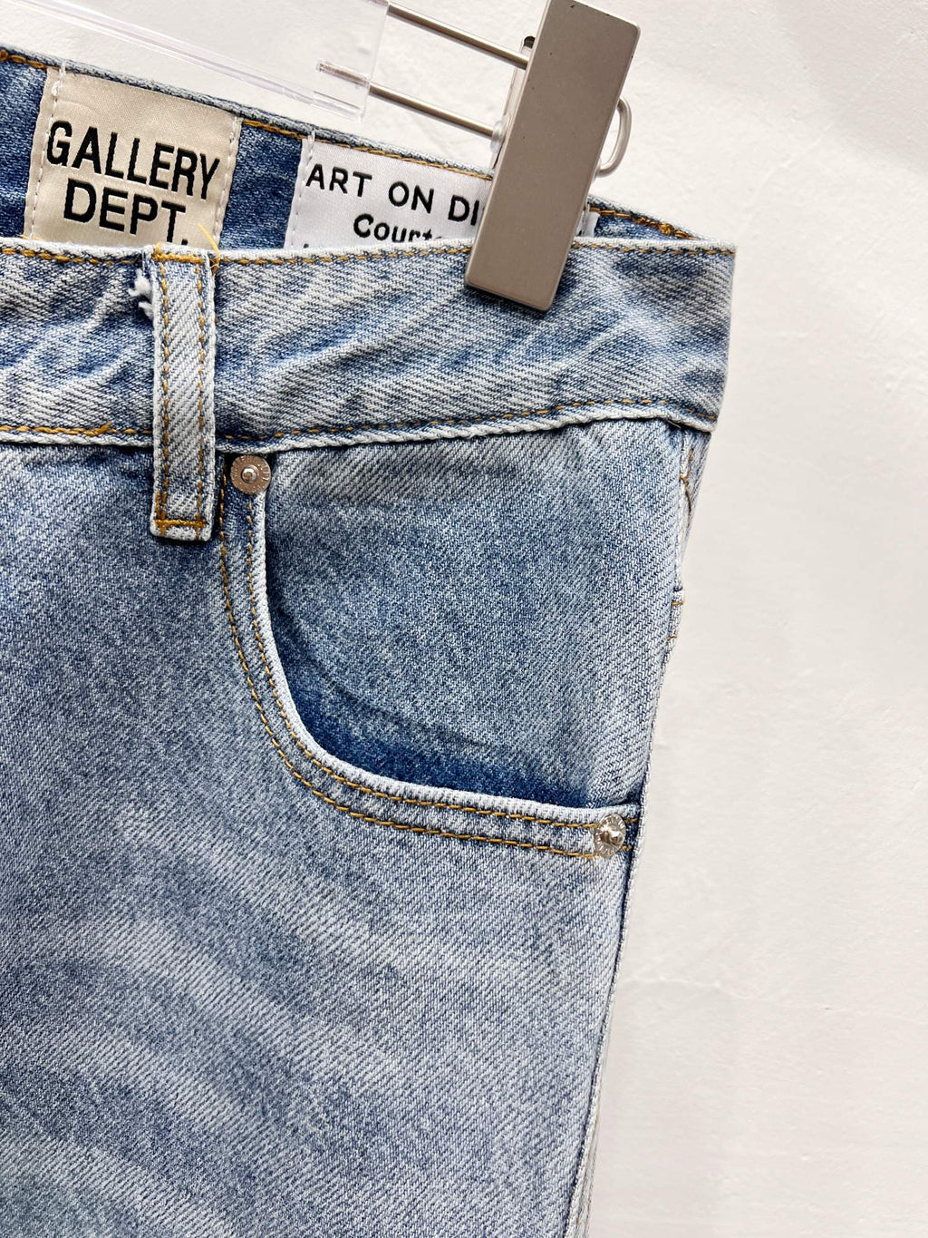Denim pants close-up of front pocket and fly with contrast topstitching