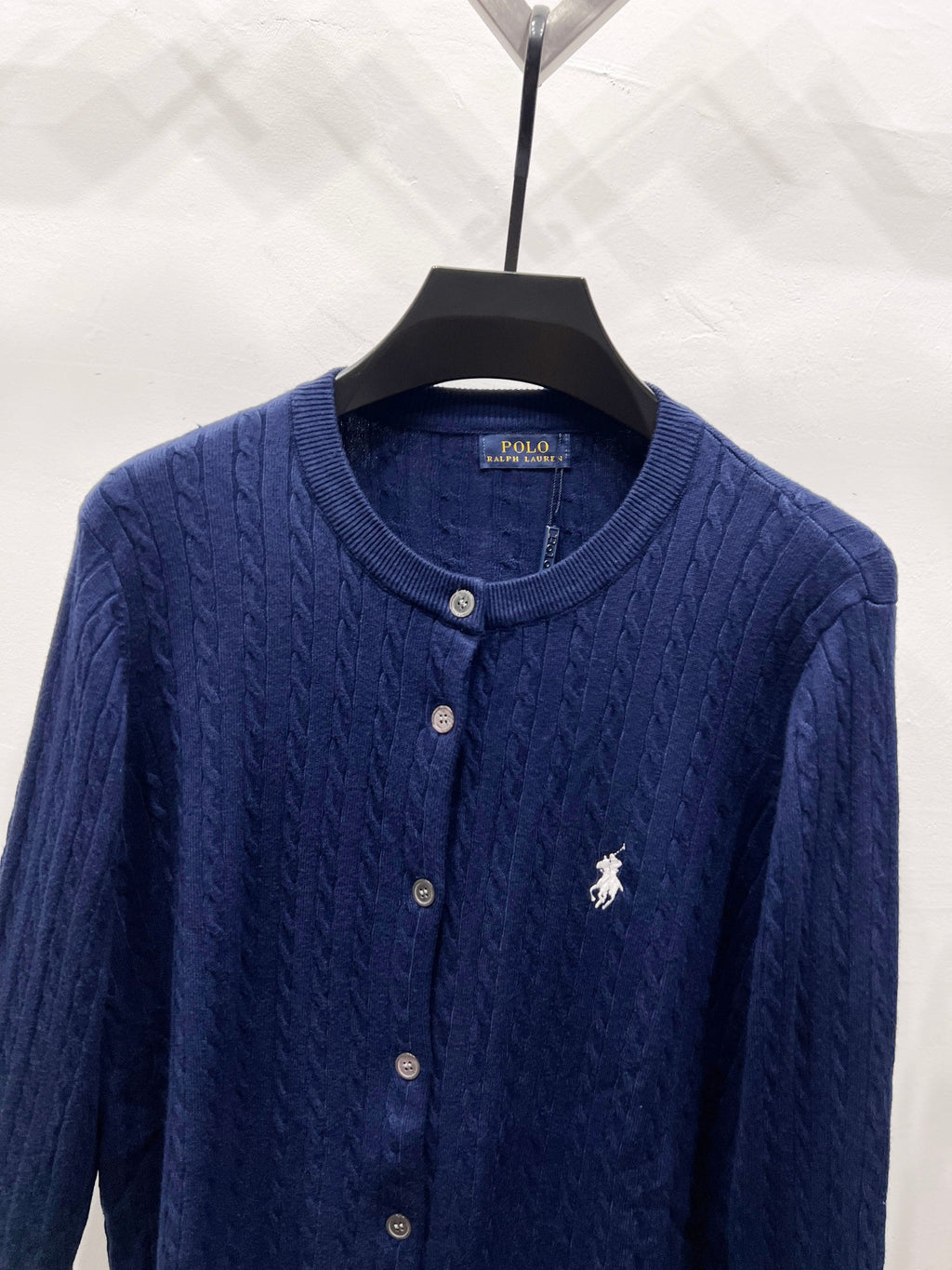 Navy blue knit cardigan with crew neck, button placket, and polo horse logo