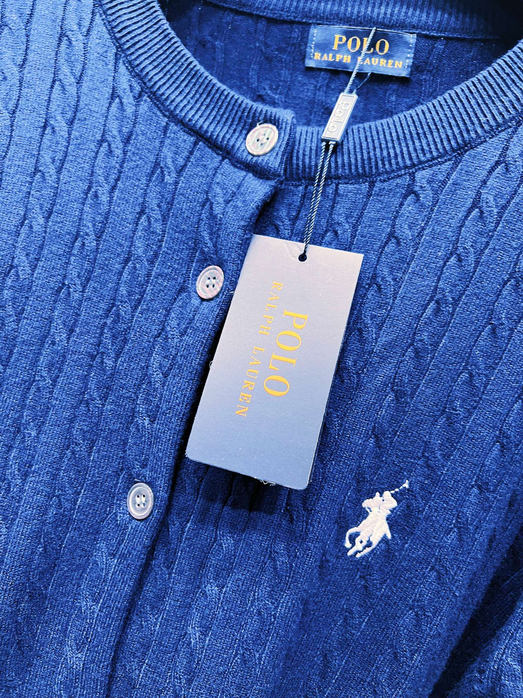 Navy blue knit cardigan neckline with buttons and embroidered polo horse emblem