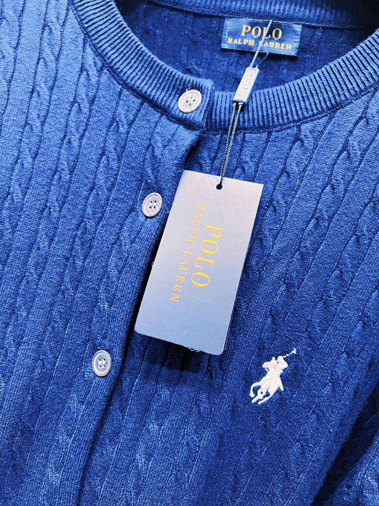 Navy blue knit cardigan neckline with buttons and embroidered polo horse emblem