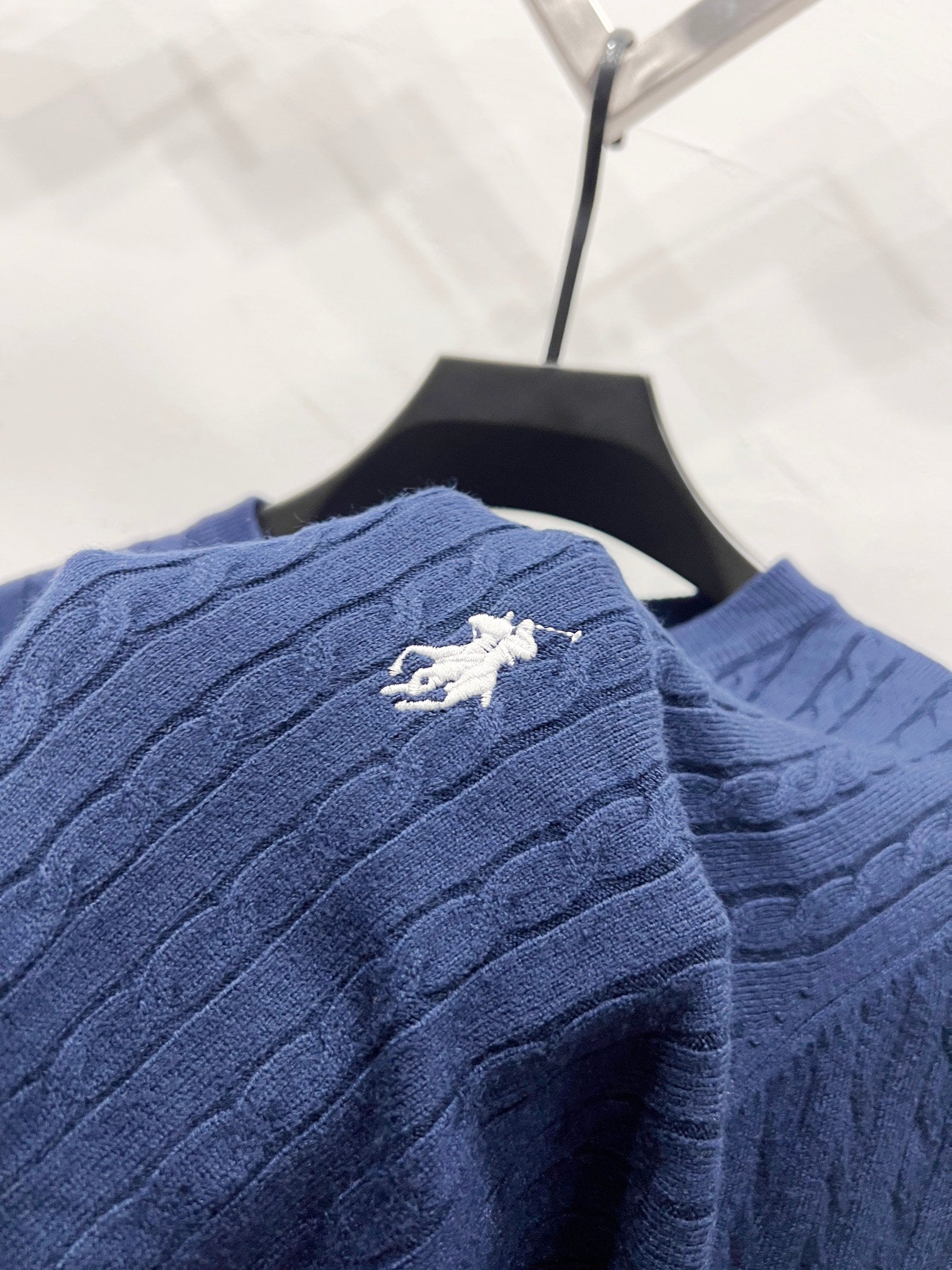 Navy blue textured knit cardigan with polo horse emblem on back