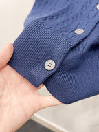 Blue rib-knit cardigan cuff with button closure