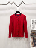 Red button-front cable-knit cardigan sweater with ribbed collar and cuffs