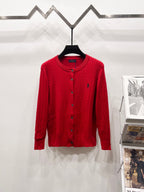 Red button-front cable-knit cardigan sweater with ribbed collar and cuffs