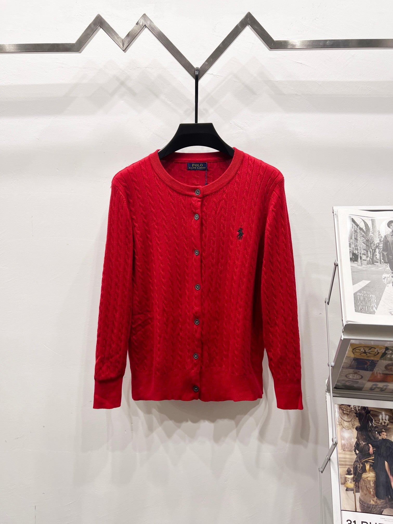 Red button-front cable-knit cardigan sweater with ribbed collar and cuffs