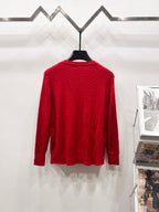 Red cable-knit cardigan sweater back view on hanger