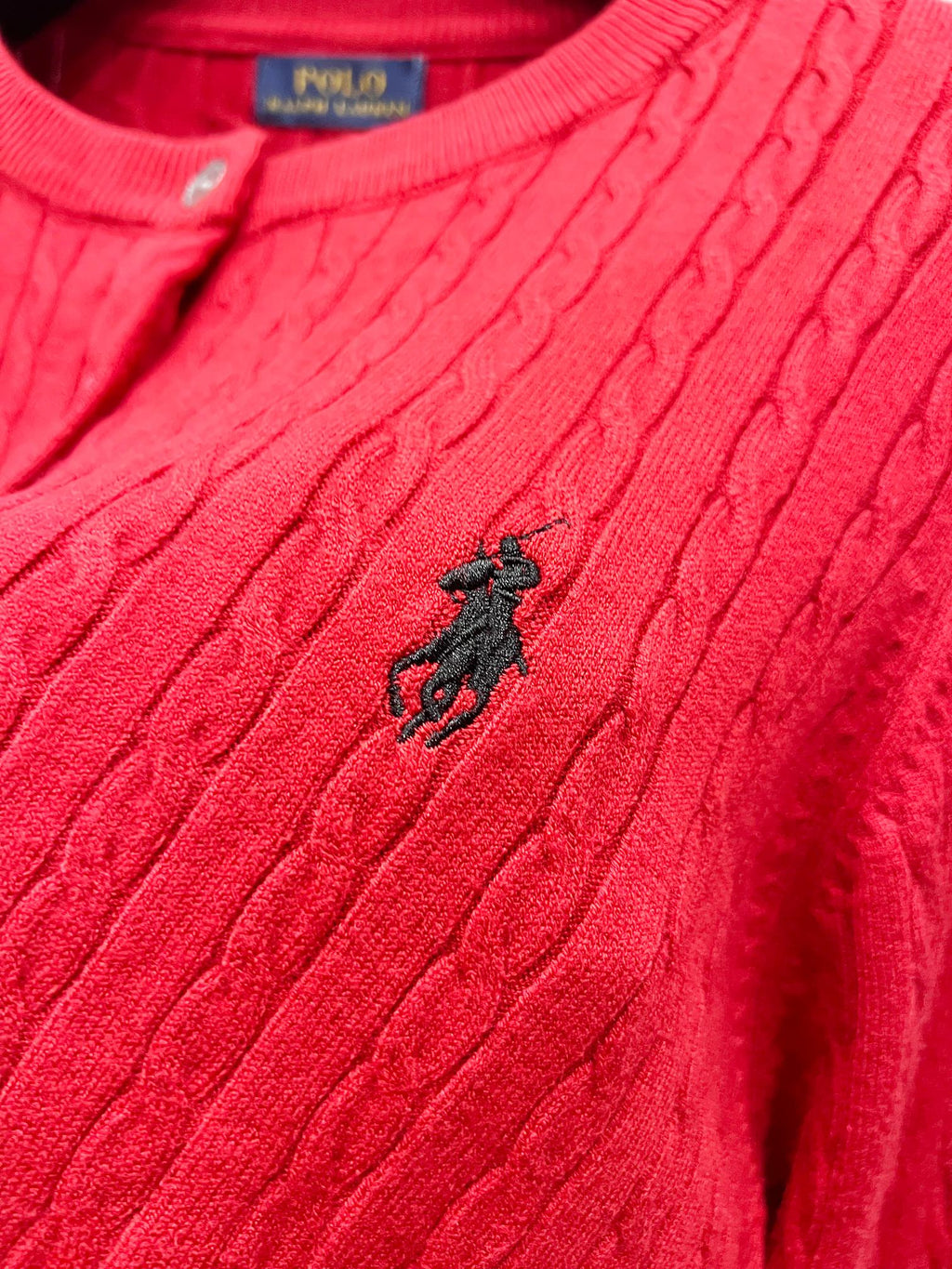 Red cable-knit cardigan sweater with small horse logo on the chest