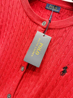 Red cable-knit cardigan close-up with Polo Ralph Lauren neck label and buttons