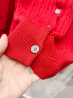 Red knit cardigan cuff with two buttons and ribbed texture detail