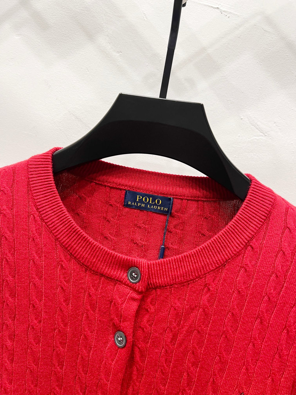 Red crew-neck cardigan sweater with ribbed collar and button placket
