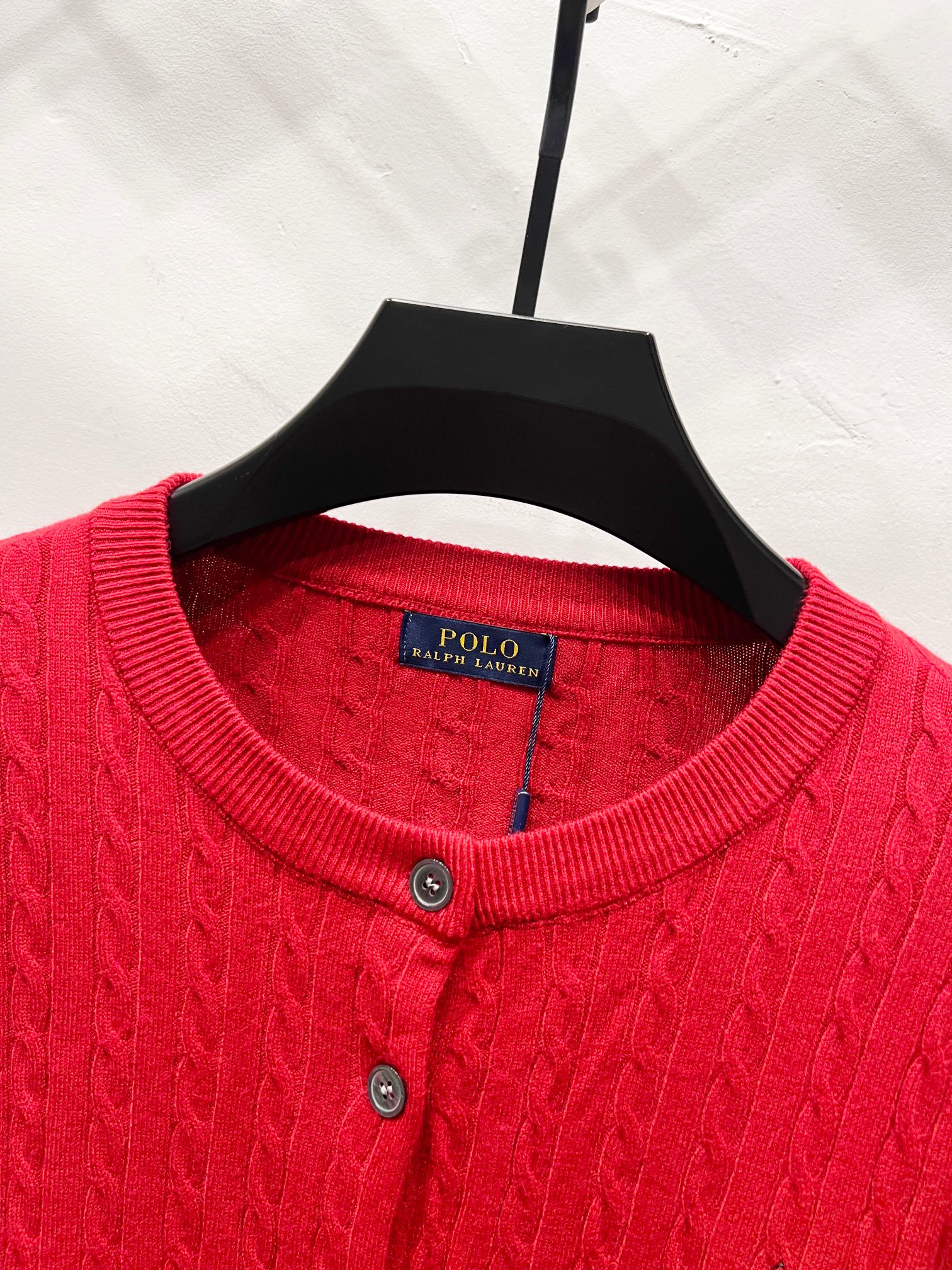 Red crew-neck cardigan sweater with ribbed collar and button placket