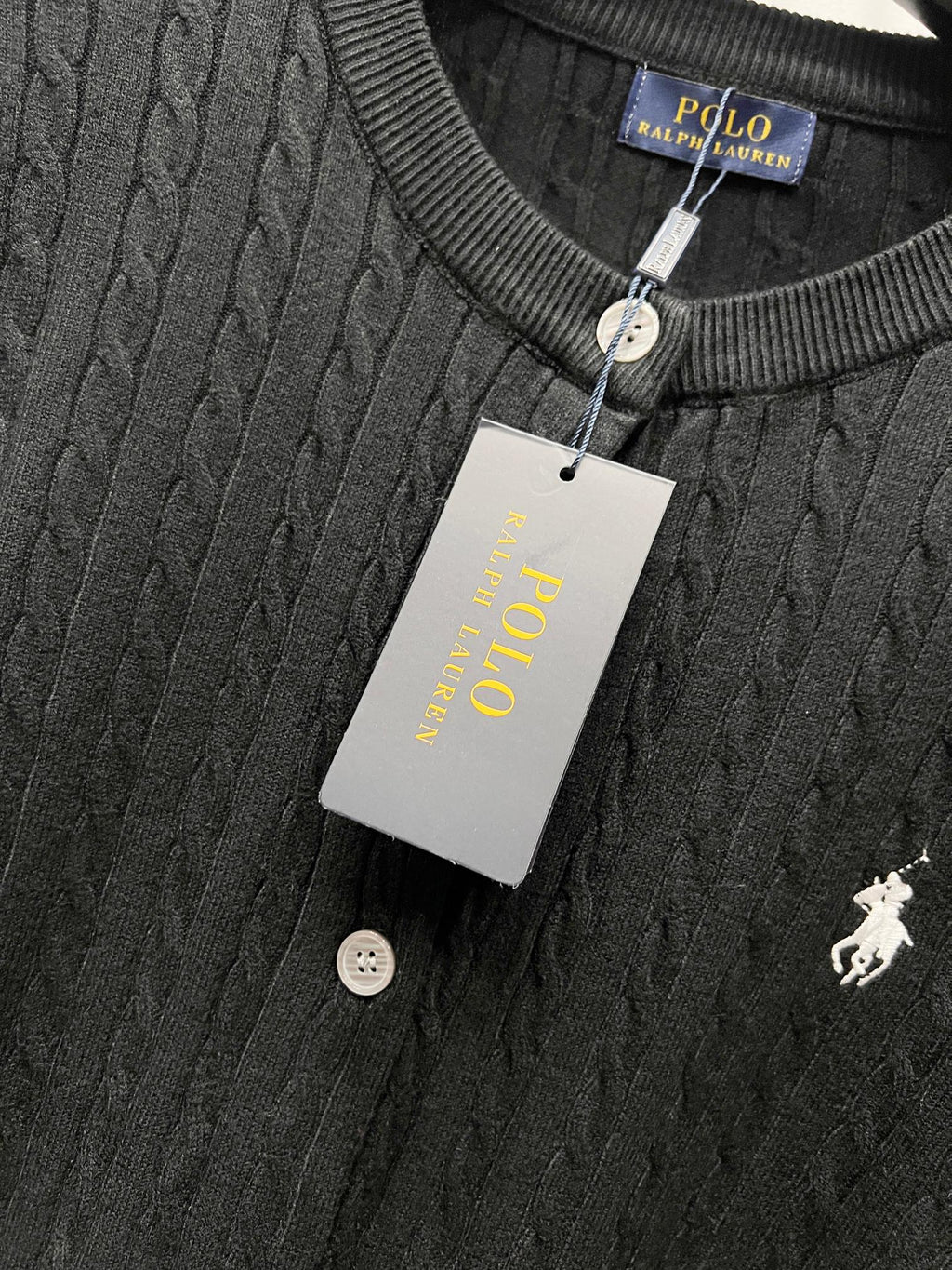 Ralph Lauren knit cardigan close-up with ribbed crew neck, white buttons, polo logo
