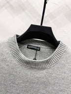 Gray crewneck sweater collar with inner label visible