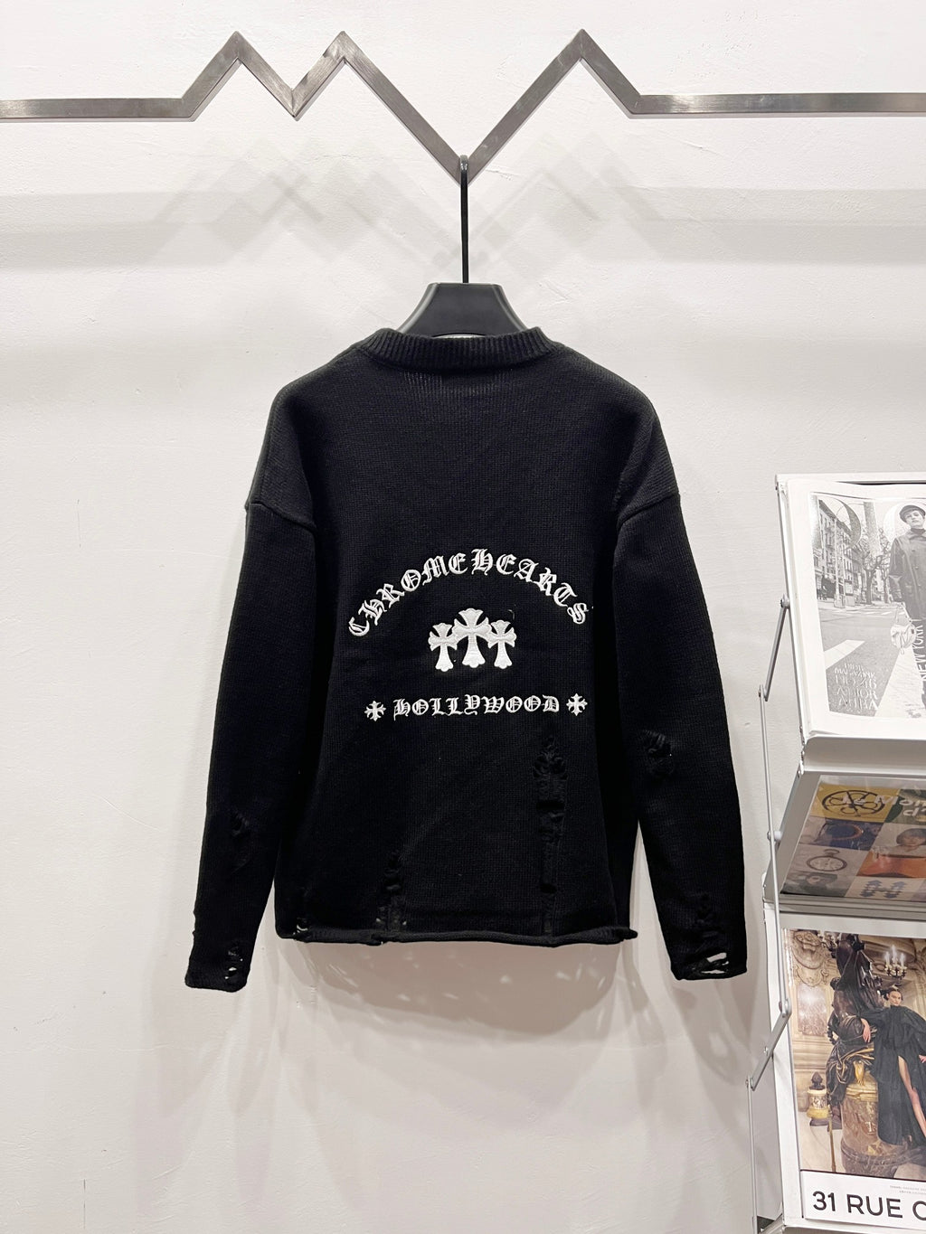 Black knit sweater with ornate white graphic print on the back yoke area