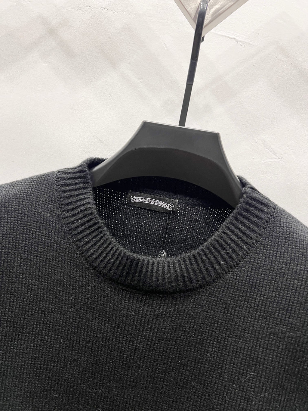 Black knit sweater neckline with ribbed collar and interior brand label
