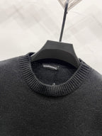 Black knit sweater neckline with ribbed collar and interior brand label