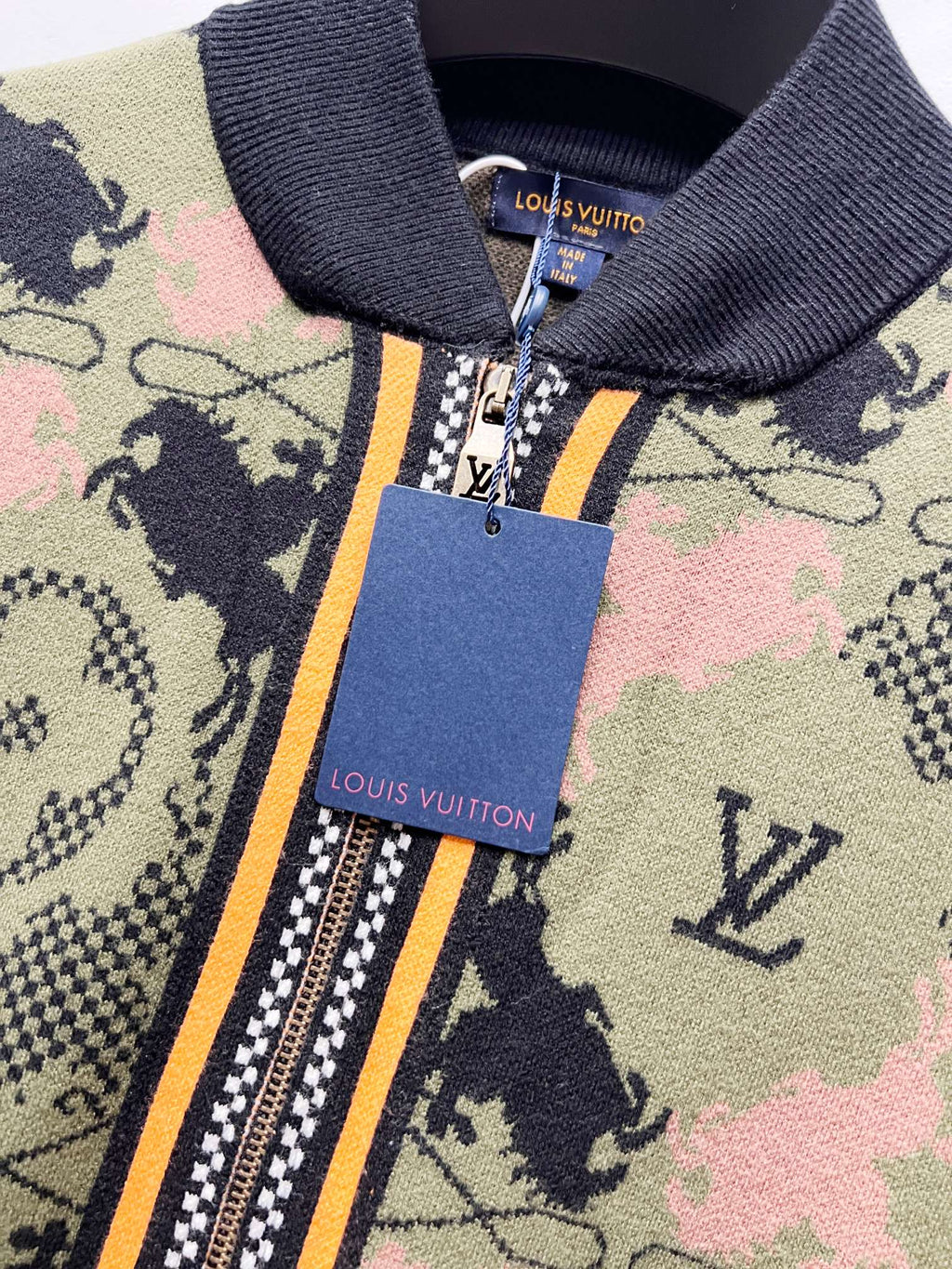 Zip-up jacket neck and zipper with gold pull and brand tag