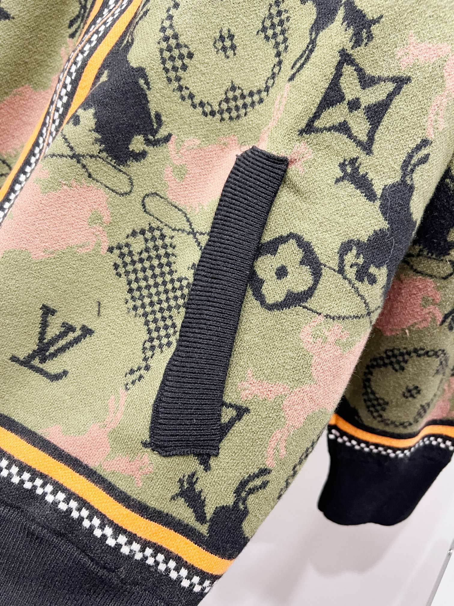 Zip-up jacket shoulder and hem with multicolor monogram knit and striped trim