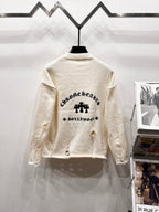 Cream long-sleeve knit sweater back with arched black text and clover graphic centered