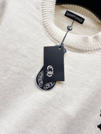 Cream knit sweater neckline with ribbed collar and hanging brand tag