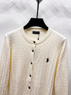 Cream knit cardigan close-up with button placket and Polo logo detail