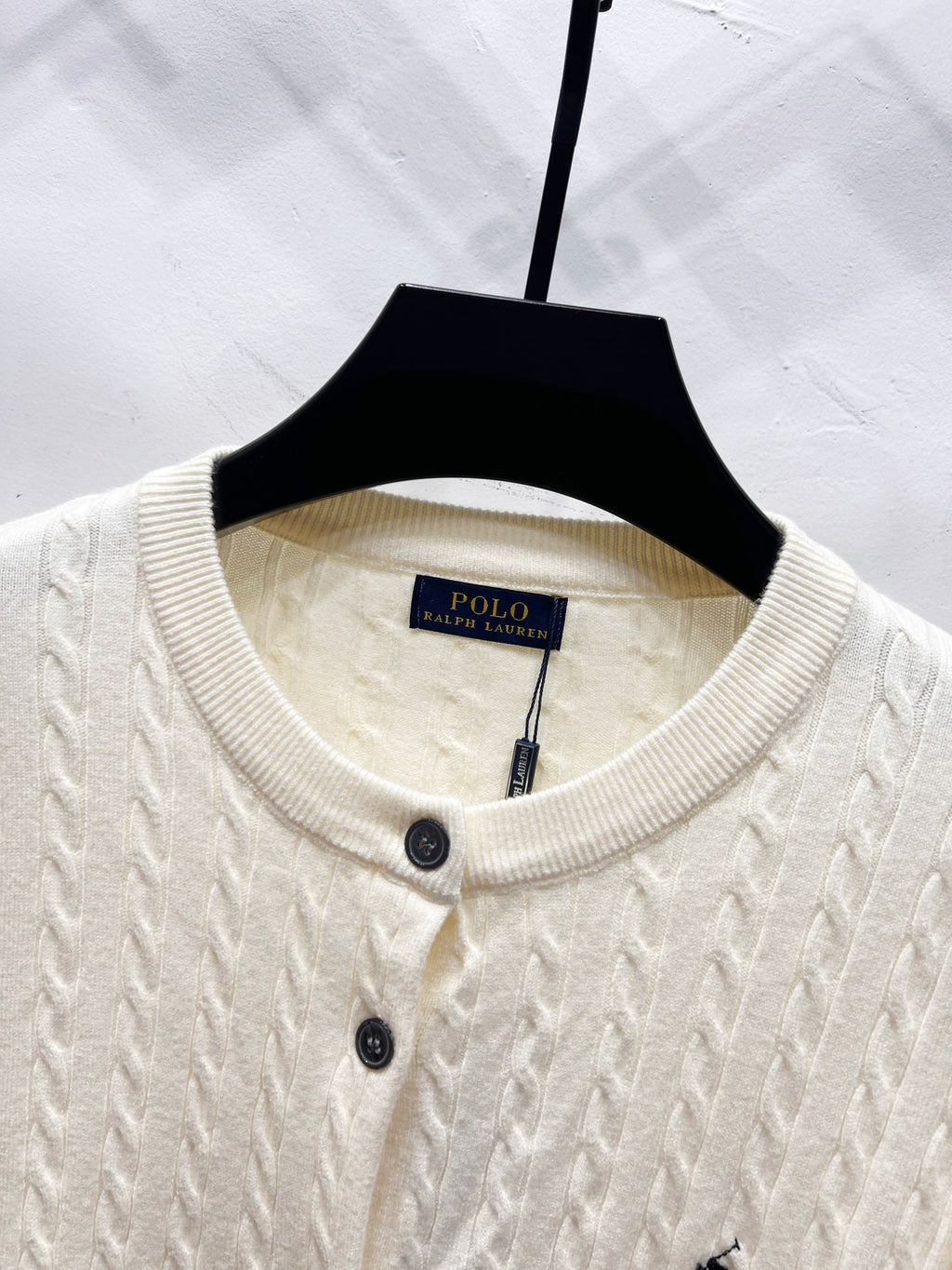 Cream knit cardigan crew neckline with buttons and Polo label at collar