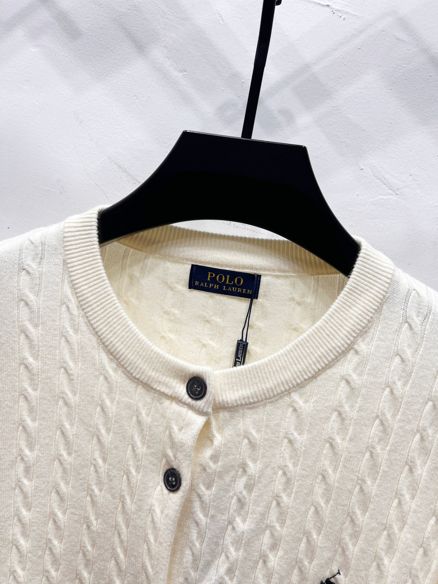 Cream knit cardigan crew neckline with buttons and Polo label at collar
