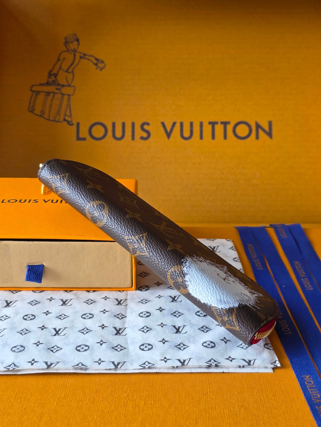 Louis Vuitton small bag, dark monogram with pink zipper trim, angled view
