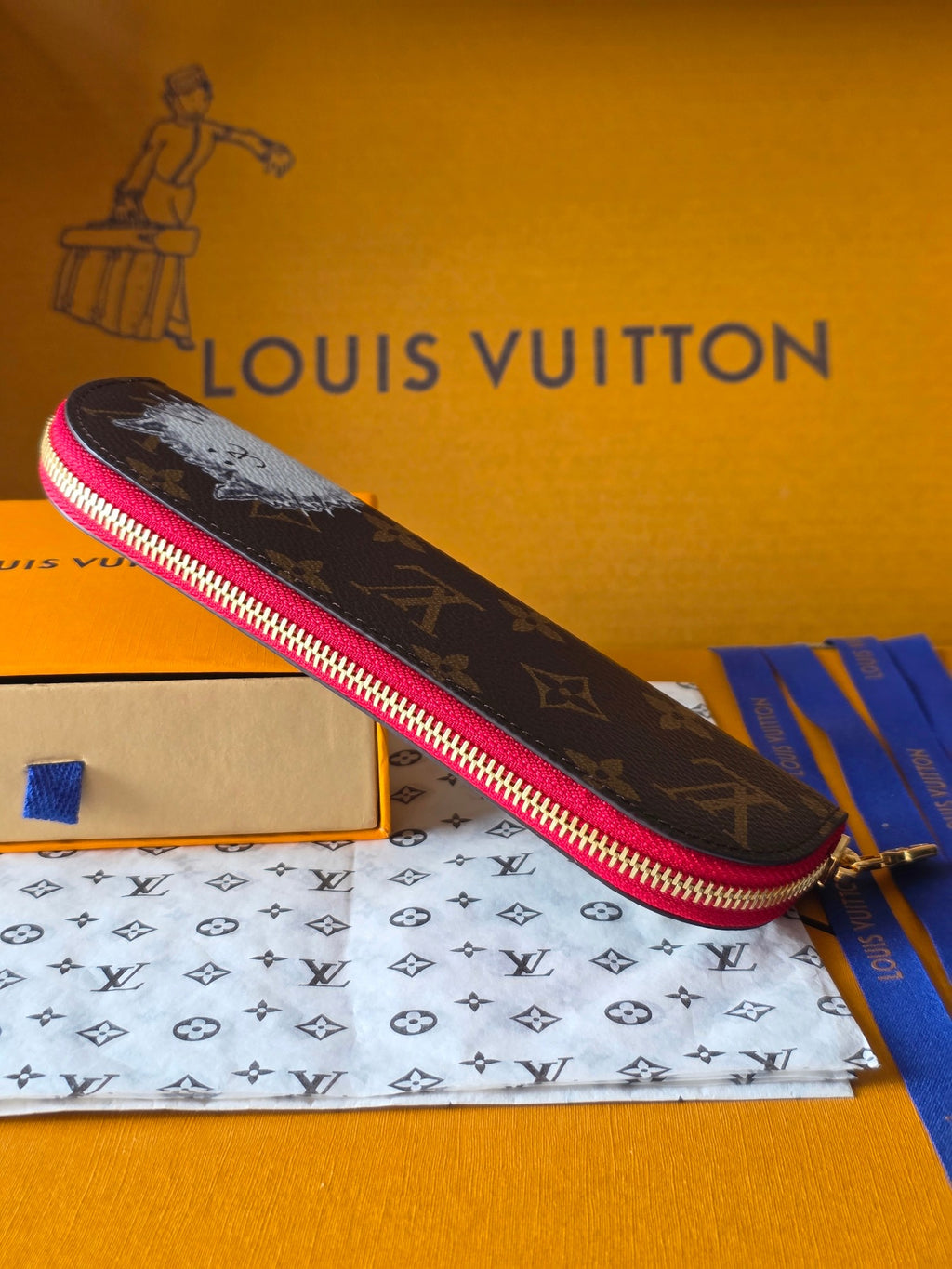 Louis Vuitton small bag in dark monogram with pink zipper border, angled front