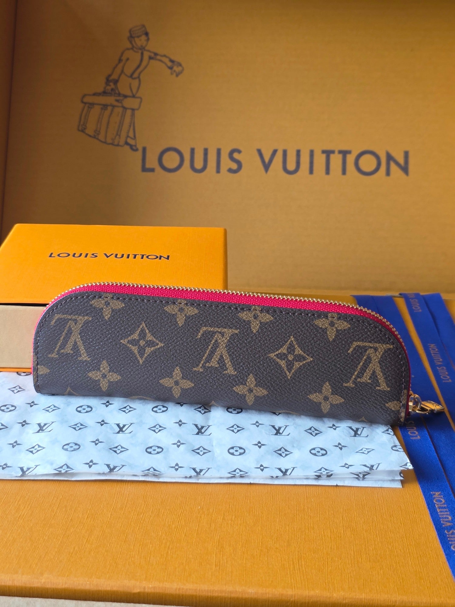 Louis Vuitton small bag with dark monogram pattern and pink-trim zipper, front view