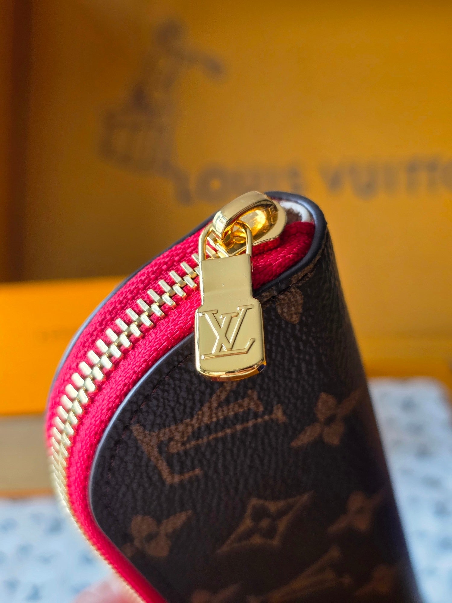 Louis Vuitton small bag with gold-tone padlock charm and pink-lined zipper