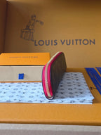 Louis Vuitton small bag in dark monogram with pink zipper trim, side view