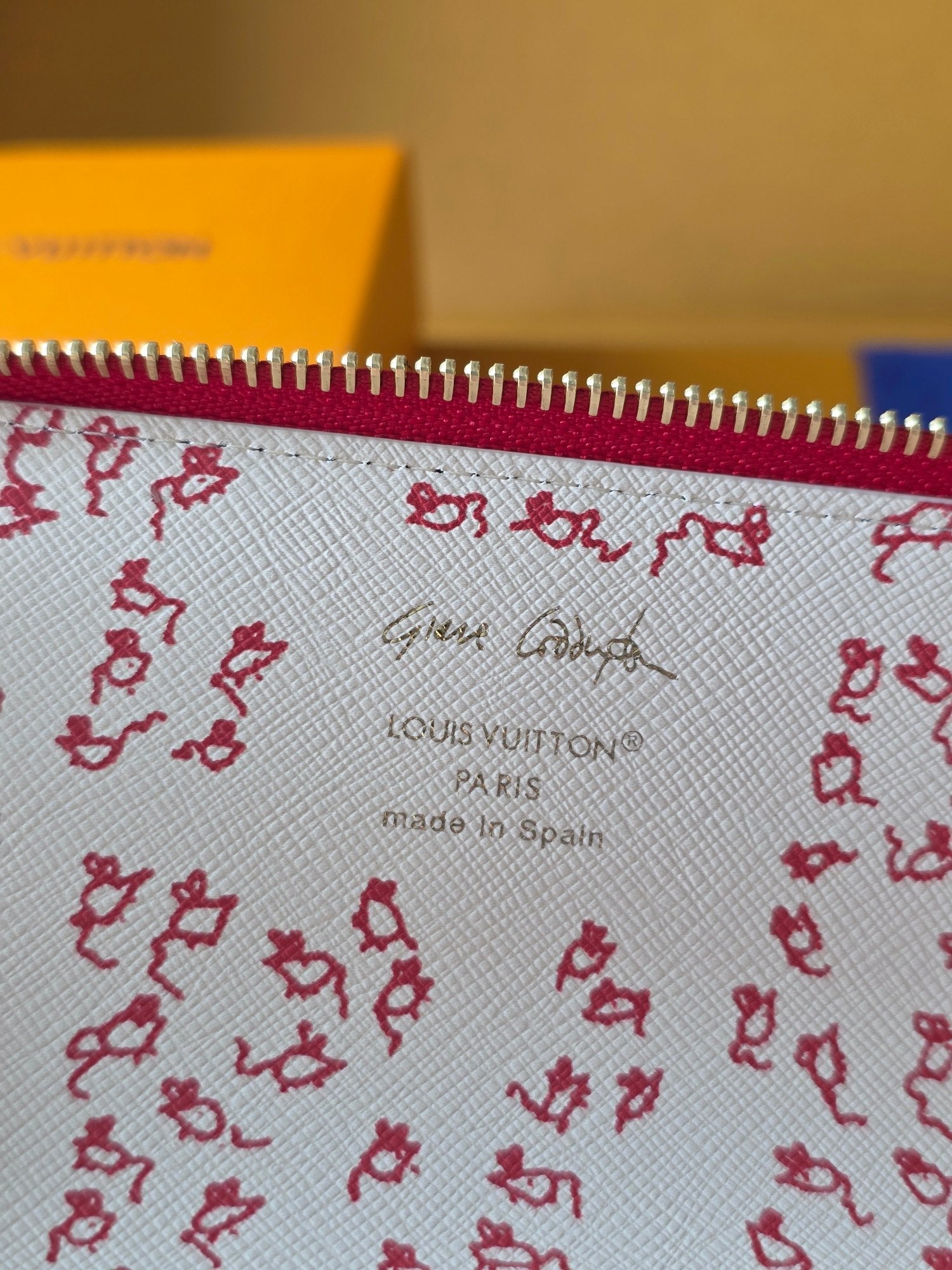 Louis Vuitton small bag lining close-up: red pattern, 'Made in Spain' text