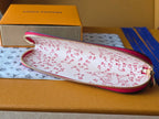 Louis Vuitton small bag with white-and-red repeating pattern and pink zipper trim