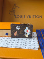 Small Louis Vuitton monogram pouch with character-style graphics and chain top