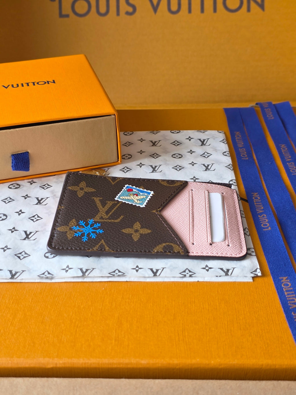 Small Louis Vuitton monogram pouch with pink interior card holder and colorful charm
